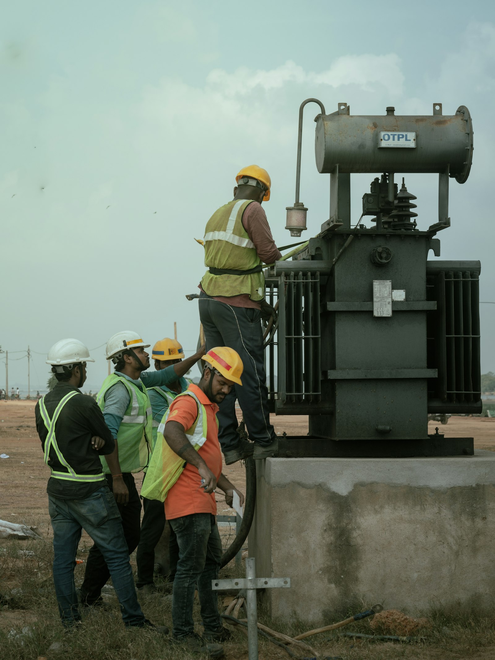 Technician performing online dissolved gas analysis on a high-voltage transformer