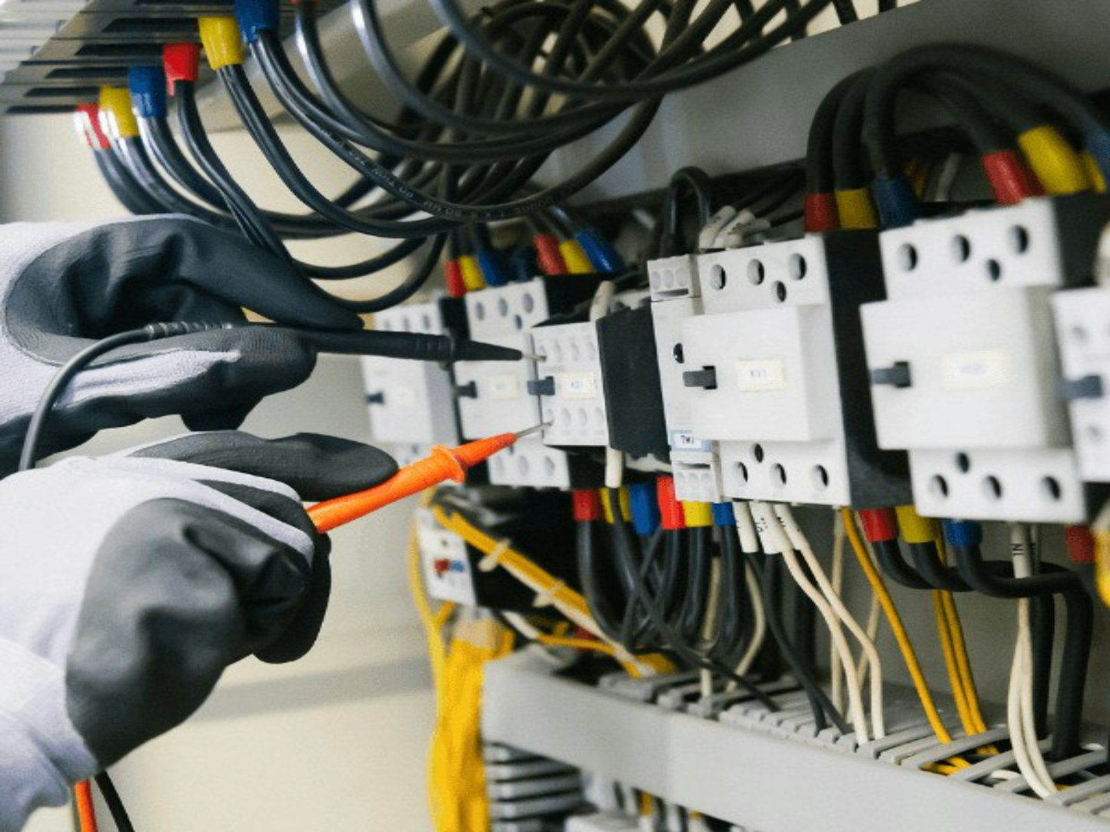 Technician servicing an electrical panel